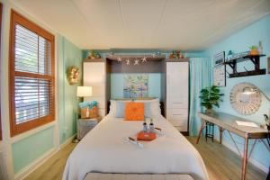 a bedroom with a large bed and a desk at Chic Virginia Beach Retreat - Pool, Steps to Beach in Virginia Beach