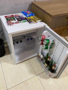 an open refrigerator with drinks in the door at Prime Hotel in Arcos