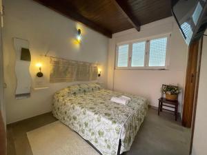 a bedroom with a bed and a television in it at Baia delle foche in Fertilia