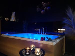 a swimming pool in a room at night with lights at La bulle D'orée in Chaudfontaine