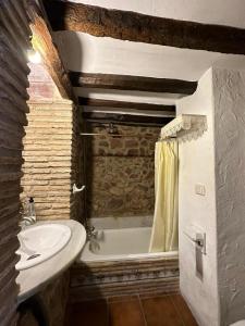 a bathroom with a sink and a bath tub at Casa Castillo in Vilafamés