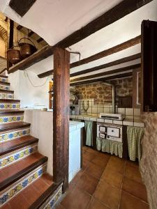 a kitchen with a stove and some stairs in it at Casa Castillo in Vilafamés