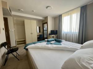 a hotel room with two beds and a window at Garni Hotel IMPERIUM Subotica in Subotica