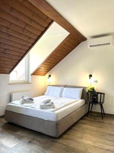 a bedroom with a large bed in a attic at Life Studio & City Bike in Bolzano