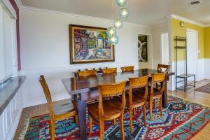 a dining room with a wooden table and chairs at Stunning Bay-View Home in Kensington! in Kensington
