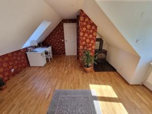 an attic room with a staircase with a desk at Cozy Country Side House in Kütke