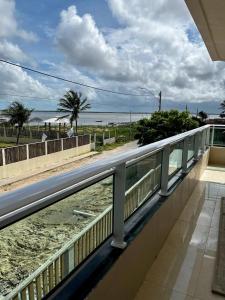 a balcony with a view of the beach and the ocean at Pousada Mar & Sol in Tutóia