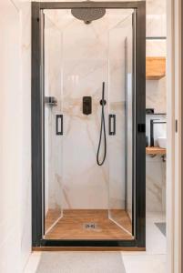 a shower with a glass door in a bathroom at Civico 2Cento - Vatican Suite in Rome