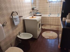 a bathroom with a sink and a toilet and a tub at Apartma Čampa in Kočevje