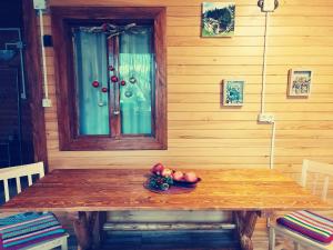 a wooden table with a bowl of fruit on it at Cabana La Bunici in Piatra Neamţ