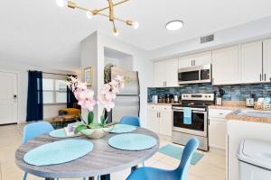 a kitchen and dining room with a table and chairs at Ocean 3 - Deep Blue in Indian Harbour Beach +34 photos