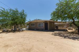 a house in the middle of a dirt road at Glamingo Cabin in Yucca Valley