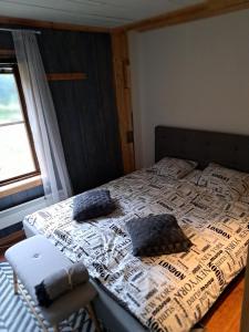 a bedroom with a bed with pillows and a window at Guesthouse Nature Trails Sweden 