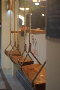 a row of wooden swings in a room at Casa Swell Coronado in Playa Coronado