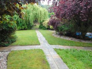 a path through a garden with grass and trees at Ubytování u Kubátů in Prachatice