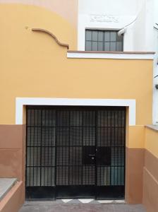 a garage door with black gates in front of a building at Private Guest House in Lima