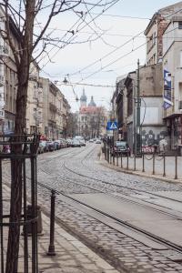 an empty city street with cars parked on the road at Kraków Wawel Zwierzyniecka in Krakow