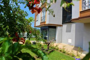 a house with a garden in front of it at KUZEY OTEL in Sinop