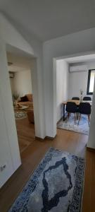 a living room with a table and a rug at Apartman Nina in Tuzla