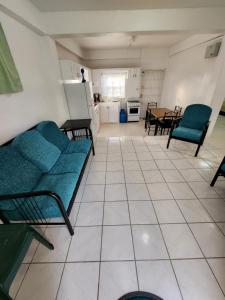 a living room with a couch and a table at Chez Emmanuel in Gros Islet