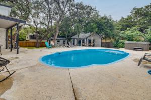 a swimming pool in the yard of a house at San Antonio Vacation Rental with Pool and Home Gym in San Antonio