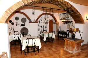 a dining room with tables and chairs in a building at Topakas House in Kambos