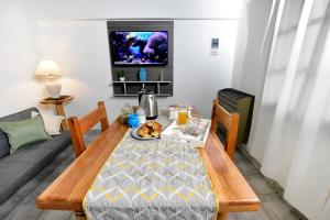 ein Tisch mit einem Teller Essen darauf in einem Wohnzimmer in der Unterkunft Cálido Destino in Ushuaia