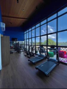 a gym with a bunch of exercise equipment in a building at Quarto no Wanderlust Experience Hotel in Campos do Jordão