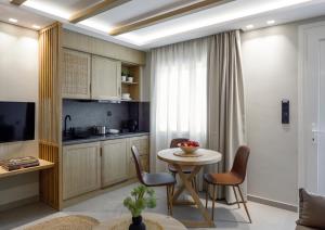 a kitchen and dining room with a table and chairs at Evelio Living in Keramoti