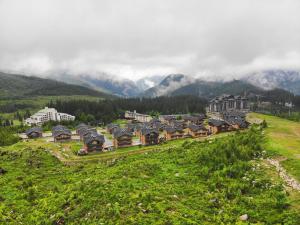 a village on a hill with mountains in the background at Mountica Jasná in Belá