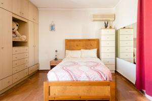 a bedroom with a wooden bed and white cabinets at Loft condo next to metro station. Amazing view! in Athens