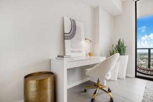 a white desk and a chair in a room with a window at Lunabase Heavenly View in Miami +48 photos