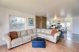 a living room with a white couch and a table at West of the Moon Ocean Apt with Beach Access! in Emerald Isle