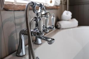 a bathroom sink with a chrome faucet on it at The Poachers Pocket in Whittingham