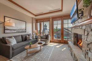 a living room with a couch and a fireplace at Luxury Condo in the Village at Northstar in Truckee