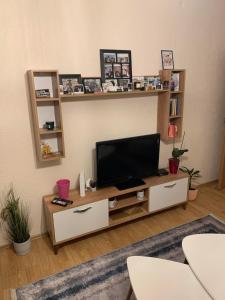 a living room with a flat screen tv on a table at Comfortable apartment close to the city center in Prishtinë