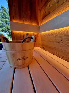 a wooden bucket sitting on top of a wooden table at Haus am See in Maria Wörth