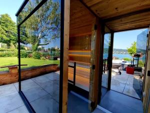 a view from the inside of a house with glass doors at Haus am See in Maria Wörth