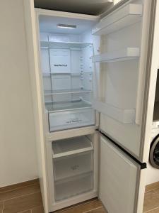 an empty refrigerator with its door open in a kitchen at Kaypa Apartaments in Pineda de Mar