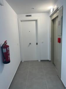 a hallway with a fire extinguisher in a room at Kaypa Apartaments in Pineda de Mar