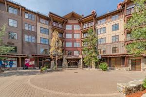 a large building with a courtyard in front of it at Luxury Condo in the Village at Northstar in Truckee