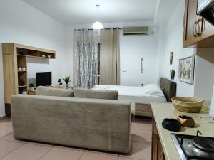 a living room with a couch and a bed at SANDY Blue Sea in Durrës