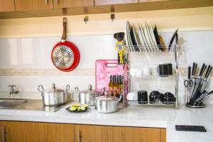 a kitchen counter with pots and pans and a sink at Feels Like HOME! in Nairobi