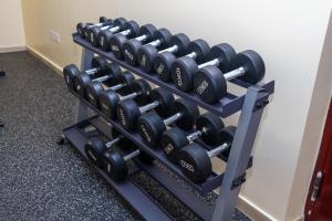 a rack of dumbbells in a gym at Feels Like HOME! in Nairobi