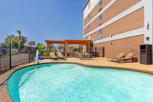 a swimming pool in front of a building at Best Western Plus Downtown North in San Antonio