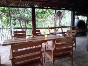 a wooden table and chairs with candles on it at Ecolodge Uh May in Francisco Uh May