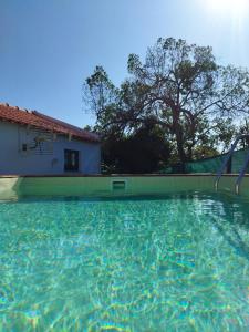 a swimming pool with a slide in front of a house at Casa da Serra in Nazaré