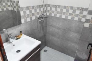 a bathroom with a sink and a shower and a sink at beautiful apartment by the beach in Saïdia
