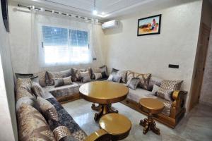 a living room with a couch and a table at beautiful apartment by the beach in Saïdia