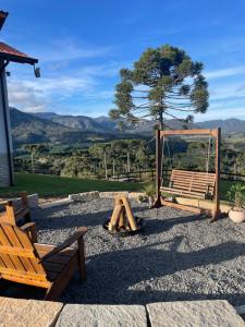 a playground with a bench and a swing at Chalé Terra Luni in Urubici